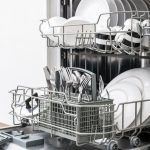 Open,Dishwasher,With,Clean,Dishes,In,The,White,Kitchen